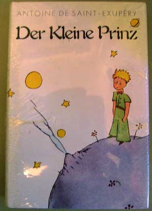 A photograph of the cover of the children’s book The Little Prince in German. The German title reads Der Kleine Prinz.