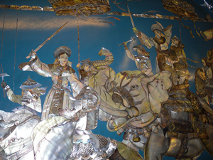 mural of women riding elephants and wielding swords