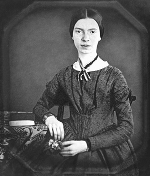 a photograph portrait of poet Emily Dickinson. She is a young woman wearing a formal dress typical of the 19th century women’s fashion. 