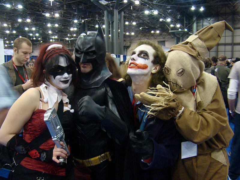 A photograph of people dressed in costumes representing Batman and several villains including the Joker