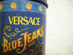 = A photograph of a can imprinted to look like denim marked with the words “Versace Blue Jeans Man”