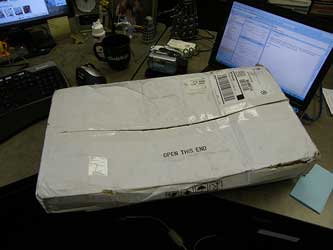 A photograph of a delivered package sitting on a desk