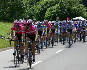 A photograph of cycling teams on a road during a leg of the Tour de France race