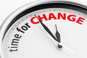 A photograph of a stop watch that has the words “Time for Change” on it.