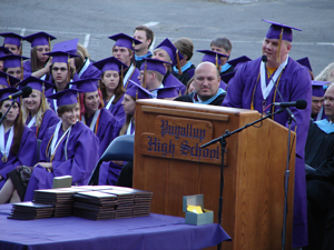 Photo of a student giving a speech at his graduation.