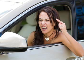 Angry female driver yelling and gesturing.