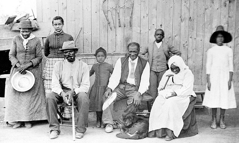A photograph of author and Civil Rights activist Harriet Tubman and a family of freed slaves. There are three children and four adults in the family.