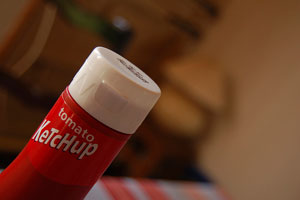 A photograph of the top of a bottle of Ketchup