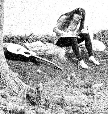 A photograph of a young woman writing in a notebook. She is seated and had a guitar next to her.