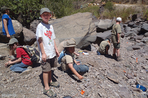 A photograph of campers resting a long a trail.