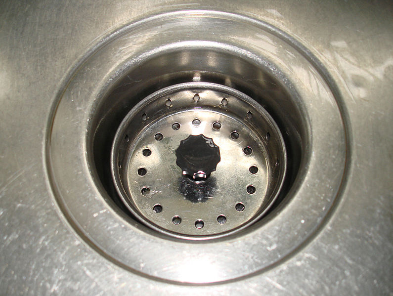 A photograph of a sink drain