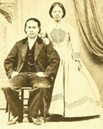 A photograph of Chinese immigrants with the man seated next to his wife