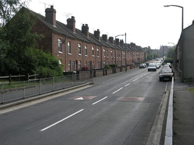 A row of brick houses on a street.