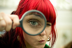 Image of girl looking through magnifying glass