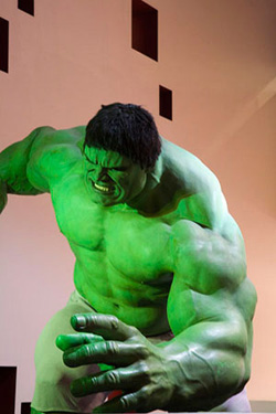 A sculpture of the Incredible Hulk, looking huge, green, angry, and monstrous.