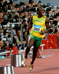 A photograph of Olympic Gold Medal track star Usain Bolt celebrating a win