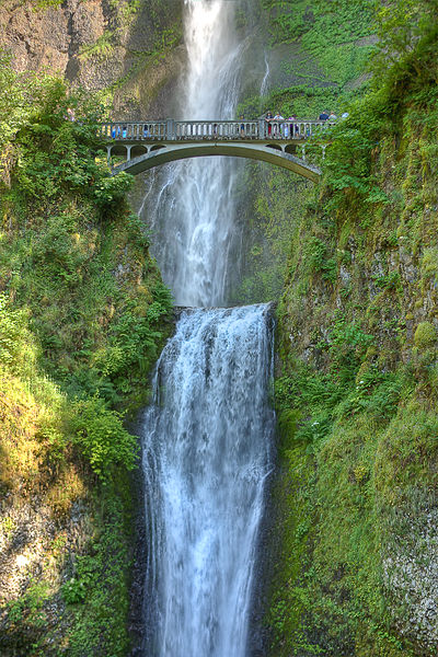 A photograph of Multnomah Falls in Oregon. In the photo is a pedestrian bridge for viewing the falls.