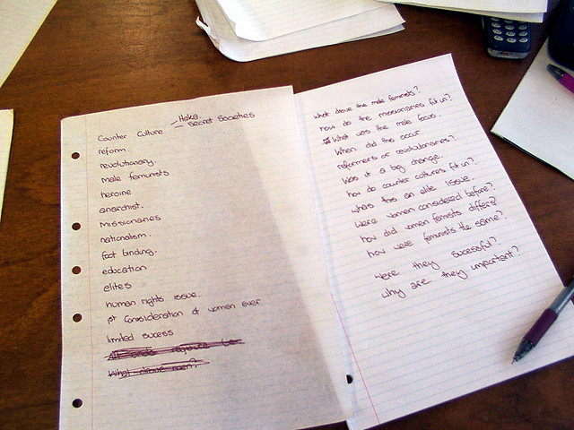 A photograph of a two sheets of lined notebook paper lying on a desk. The papers have wiring on them and a pen lying beside them.