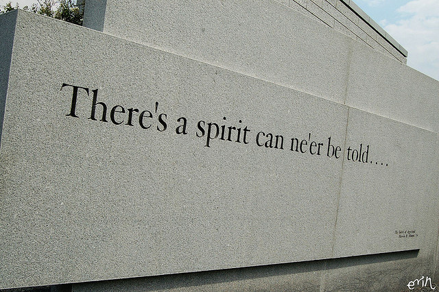 A photograph of the Texas A&M bonfire memorial that reads 'There's a spirit can ne’er be told...'