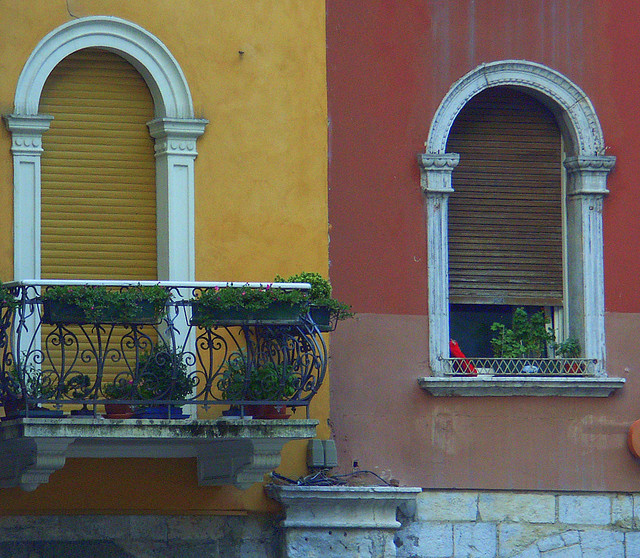 A photograph of two similar window frames on different colored walls