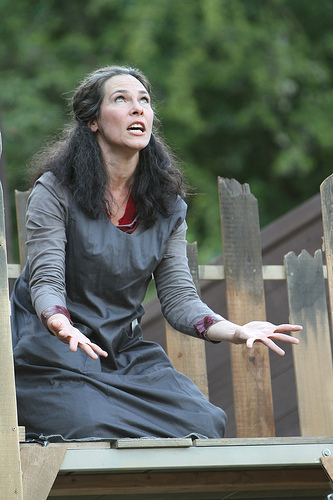 A photograph of an actress playing Lady Macbeth acting out a scene in William Shakespeare’s “Macbeth”