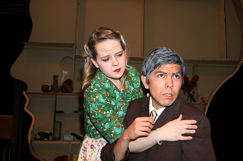 A photograph of two actors acting out a scene in a play