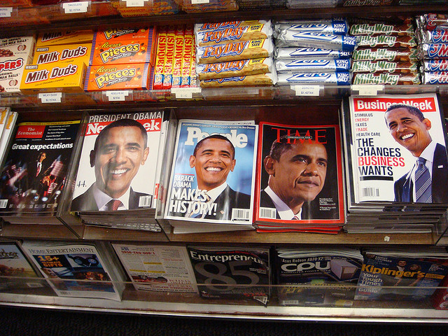 A photograph of various new magazines featuring President Obama on the cover in an airport newsstand