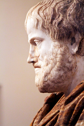 A marble bust of Aristotle as a middle aged man with a full bear