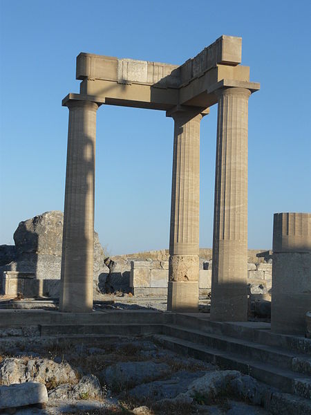 A photograph of three ancient Greek columns at an archaeological site