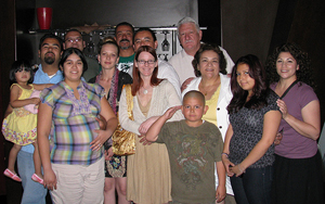 A photo of an extended family with 10 adults, 1 teenager, and 2 children