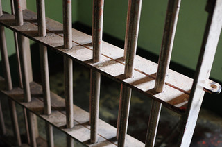 A photograph of bars in a jail cell
