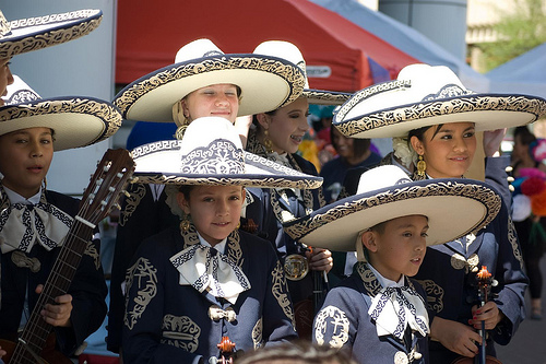 A photograph of a youth Mariachi band in full mariachi uniform