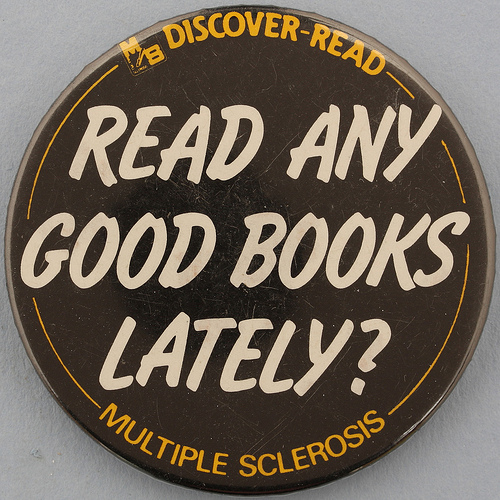 A photograph of a button that reads: “Read Any Good Books lately?”