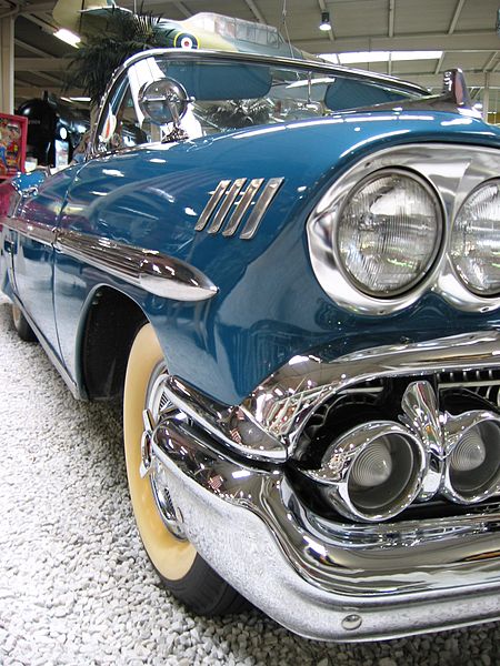 A photograph of the right front fender of a very sparkly ’57 Chevy Impala