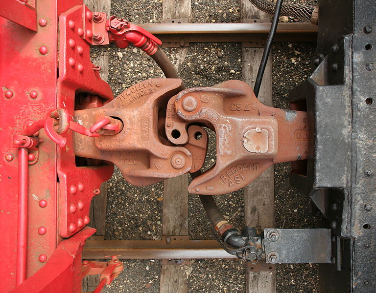 photo of the two industrial iron hooks that connect two train cars