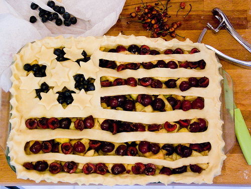 A photograph of a pie made up to look like an American flag