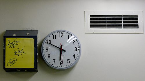 A photograph of a school clock that reads 6:50