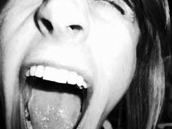 An up close photograph of a girl screaming