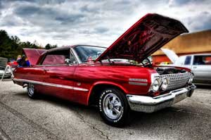 A photograph of a hot rod with the hood open.