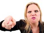 A photograph of an angry woman pointing her finger at the camera