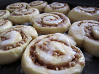 A photograph of a tray of freshly baked cinnamon rolls