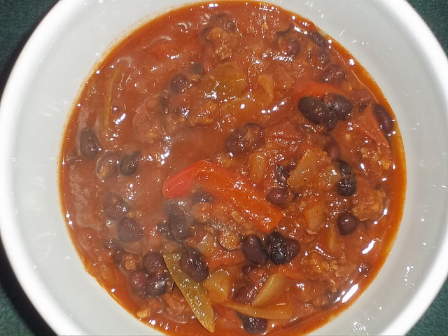 A photograph of a ceramic bowl of chili.