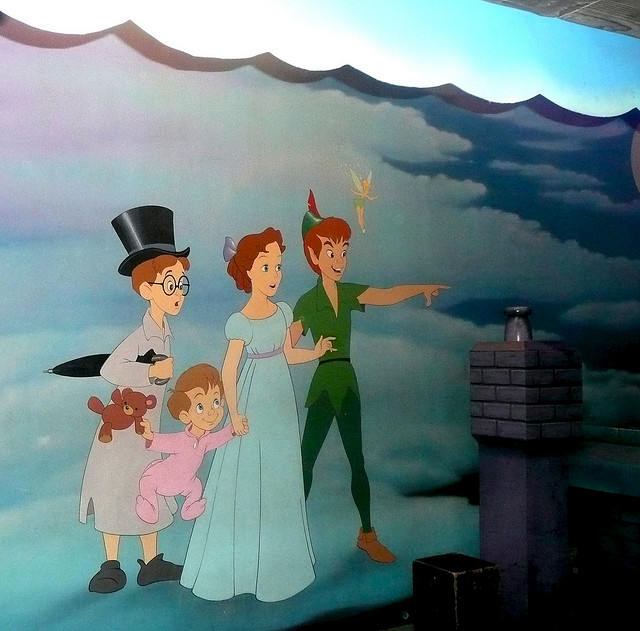 A painted mural featuring the Darling children and Peter Pan standing on a cloud.