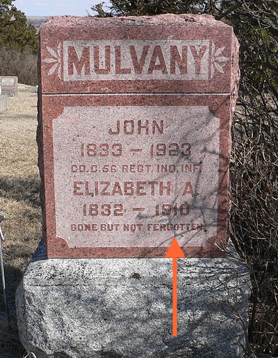 Photo of tombstone that reads: Mulvaney, John, 1833–1923, military designation, Elizabeth A., 1832–1910, Gone But Not Fergotton. The “For” in “Forgotten” is misspelled with an “e”. It should be an “o”.