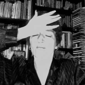 black and white photo of a woman bumping her hand against her forehead as though she forgot something
