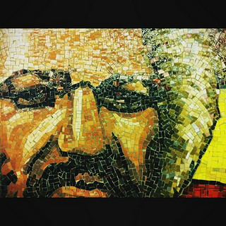 A photograph of a mosaic of the face of Frederick Douglas. It depicts him as an older man with white in his hair.