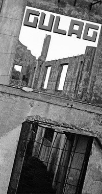 A stark black and white image form Alcatraz, showing an abandoned and decayed concrete prison block.