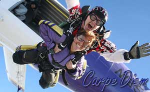 An older couple sky-dives out of a plane.