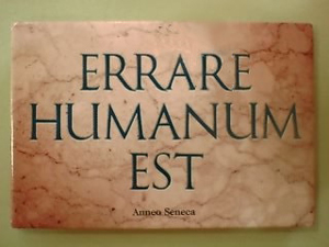 A photgraphof a sign in Latin that reads “Errare Humanum Est” or “To err is human”