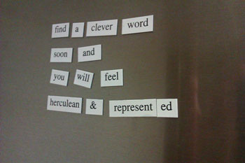 Magnetic poetry on a gray metal surface. The poetry reads, “find a clever word soon and you will feel herculean and represented.”